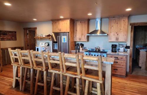 Joseph House | Lakefront home with wraparound deck modern appliances WiFI & dog-friendly