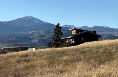 Ennis House | Scenic Vacation Home with Wrap-Around Deck Overlooking Ennis Lake near McAllister, Montana