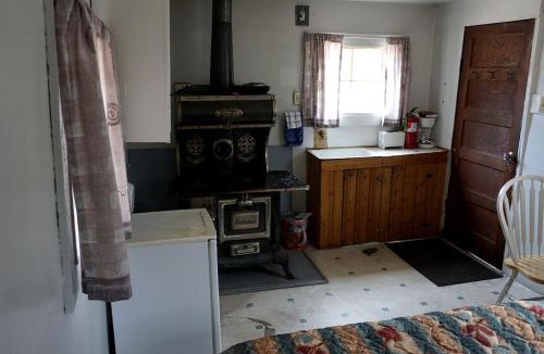 Bellvue House | Simple Country Cabin with Ornate Wood Stove in the Colorado Mountains of Poudre Canyon