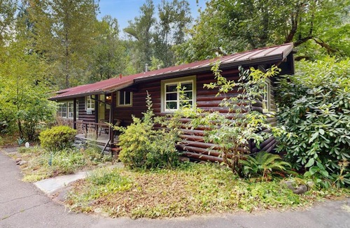 Molalla House | Tranquil landscape with riverside firepit gas grill gas fireplace and deck